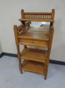 A pine three tier mirrored back telephone table fitted a drawer