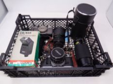 A basket containing a Canon AE-1 camera together with a further Canon camera, lenses,