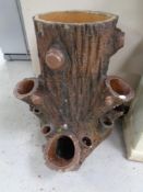 A large pottery planter in the form of a tree stump