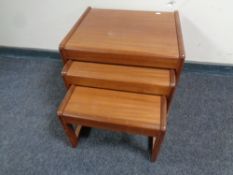 A nest of three mid 20th century teak tables