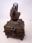 A plated eastern style jewellery casket surmounted by a bird