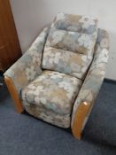 An Ercol manual reclining armchair upholstered in a floral fabric