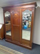 A 19th century inlaid mahogany triple door wardrobe