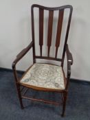 An Edwardian mahogany high backed armchair