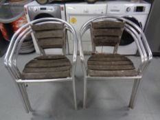 A set of six wooden and tubular metal patio armchairs