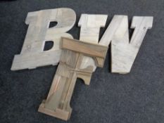 A crate containing three large wooden letters,