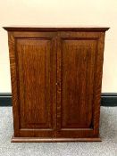 An Edwardian oak double door cabinet, width 54 cm.
