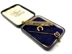 A stick pin with 9ct gold head together with an antique 'Baby' brooch