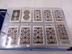An album containing Wills and Players cigarette cards,