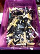 A plastic storage box containing a large quantity of silver plated and stainless steel flatware