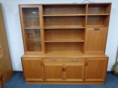 A mid 20th century teak G Plan cocktail sideboard fitted four cupboards and drawers beneath,