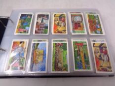 An album containing Brook Bond tea cards, sports, wildlife,