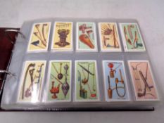 An album containing cigarette cards by Wills, Player and Churchman to include medals, churches,