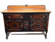 An Edwardian oak sideboard, fitted with two drawers above two cupboard doors, width 152 cm.
