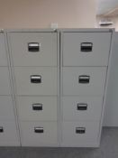 Two four drawer metal filing cabinets with keys