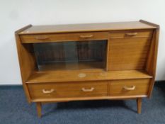 A 20th century teak sliding glass door sideboard