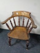 An antique elm and beech smoker's armchair