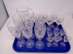 A tray of three sets of six Stuart Crystal glasses together with a cut glass lead crystal water jug