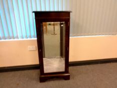 A reproduction mahogany illuminated cabinet,