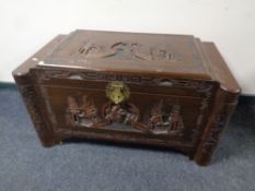 An oriental carved camphor wood blanket box