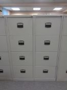 Two four drawer metal filing cabinets with keys