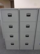 Two four drawer metal filing cabinets with keys