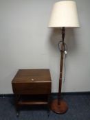 A beech standard lamp with shade together with a 20th century flap sided two tier tea trolley