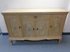 An early twentieth century continental four door sideboard on raised legs