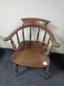 An antique elm and beech smoker's armchair
