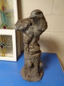 A concrete garden figure of an eagle on plinth