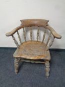 An antique elm and beech smoker's armchair