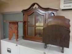 A carved hardwood wine table together with a magazine rack and wall cabinet