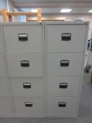 Two four drawer metal filing cabinets with keys