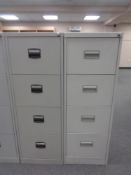 Two four drawer metal filing cabinets with keys