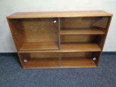 A 20th century teak sliding glass door bookcase