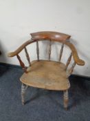An antique elm and beech smoker's armchair