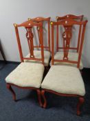 A contemporary set of four dining chairs on cabriole legs