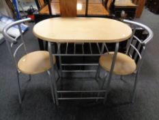 A contemporary oval kitchen table with two stowaway chairs
