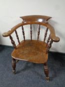 An antique elm and beech smoker's armchair