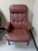 A Scandinavian stained beech high back armchair upholstered in brown leather