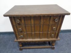 A 20th century three drawer chest in an oak finish