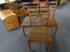 A set of three mid 20th century Danish teak Arne Larsen ladder back chairs