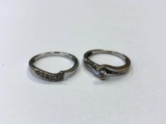 A 9ct white gold diamond set cross over ring,