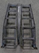 A pair of metal car ramps