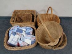 Six assorted wicker baskets and a hand stitched bed throw