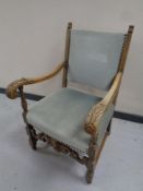 An early 20th century scroll-arm armchair