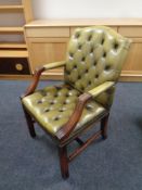 A green button leather and mahogany desk armchair