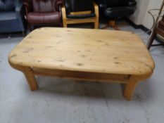 An oval pine coffee table