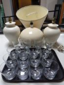 A tray of assorted drinking glasses together with a pair of ceramic table lamps with shades and a