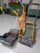A folding metal wheel barrow frame together with a Black & Decker lawn raker,